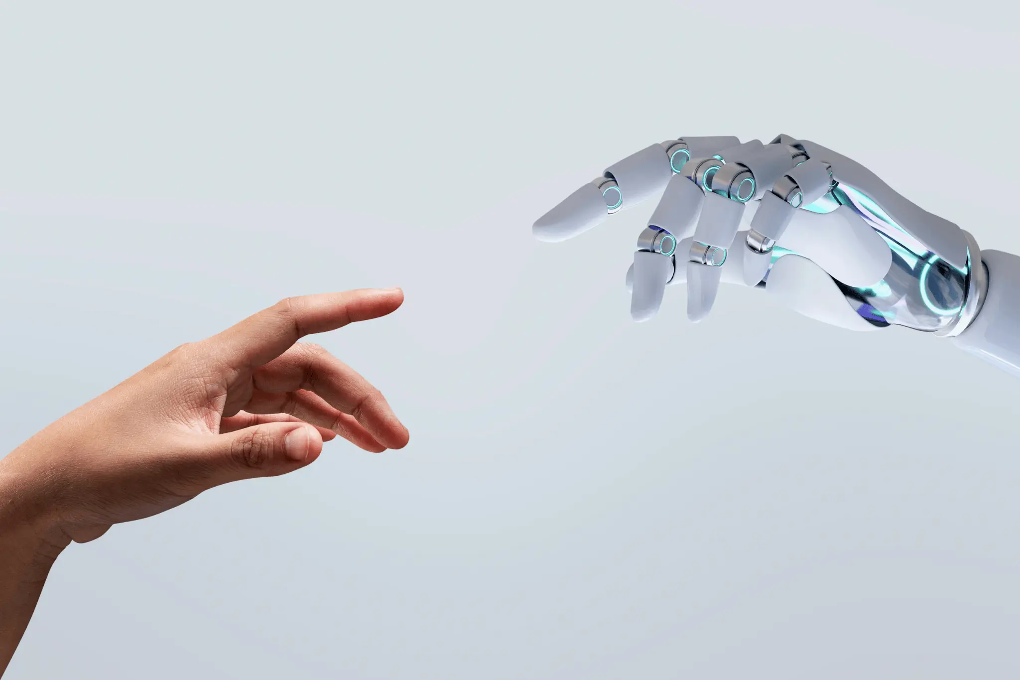 human hand reaching toward a robotic hand with glowing joints, symbolizing collaboration between people and ai